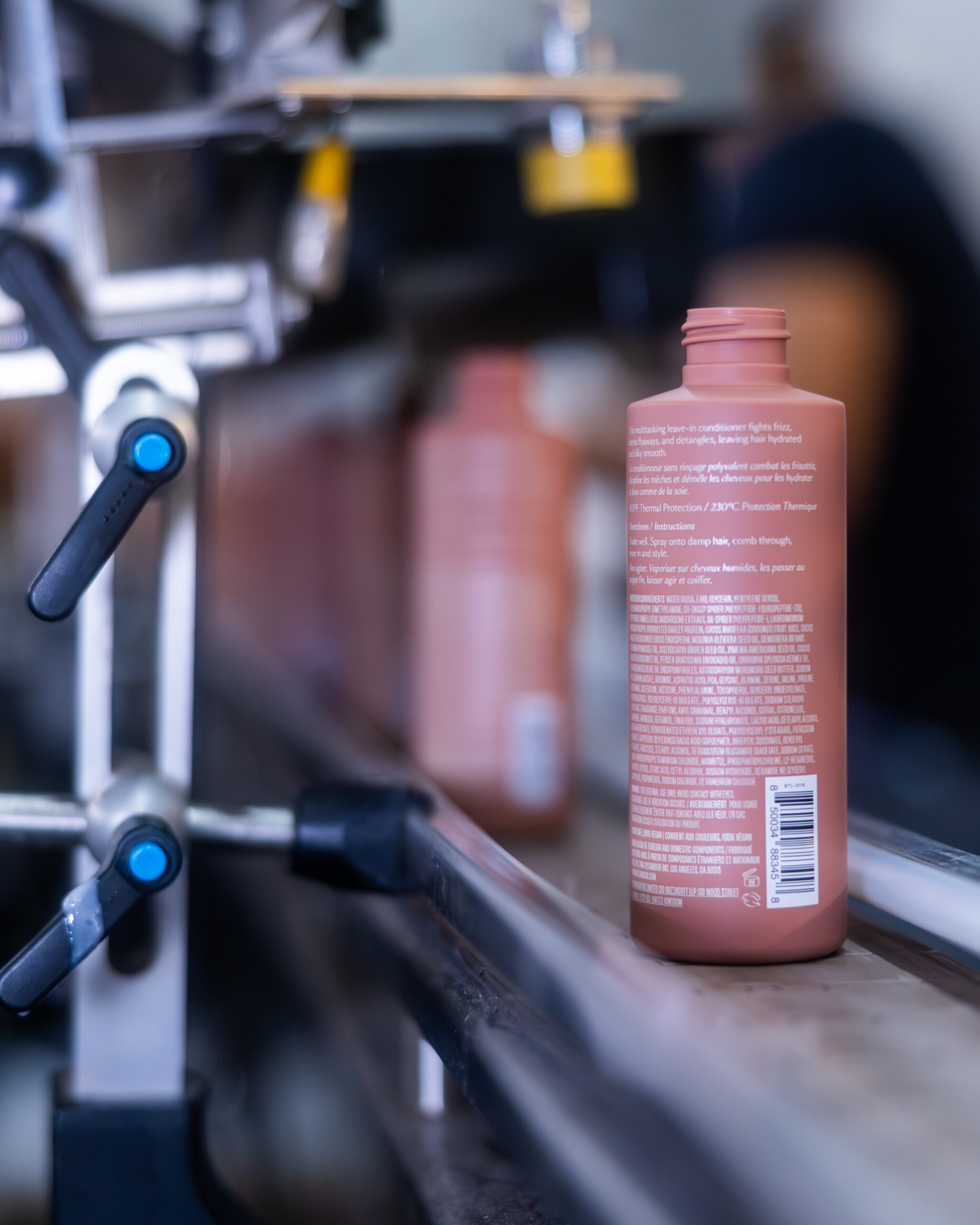 AMR Labs production filling line Labeled cosmetic bottle on AMR Labs production line during filling and quality control
